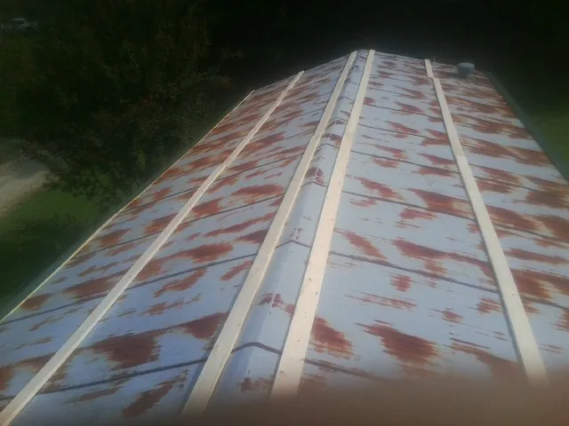 Rusted metal roof panels with new wood purlins before replacement — Storm Damage Roof Repair in Pittsburg by Roofing Brothers